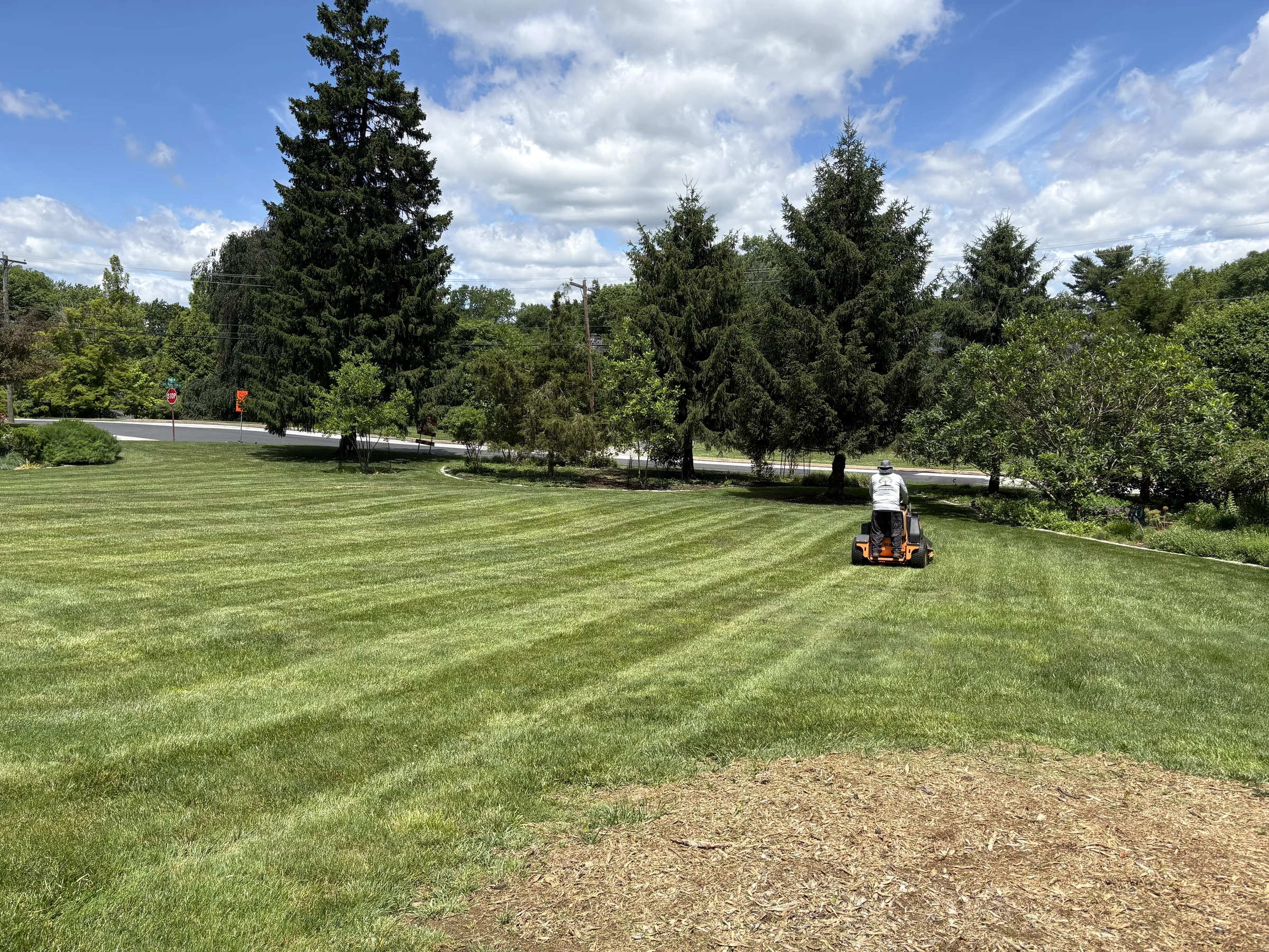 Wide striped lawn maintained by Worthy Landscaping