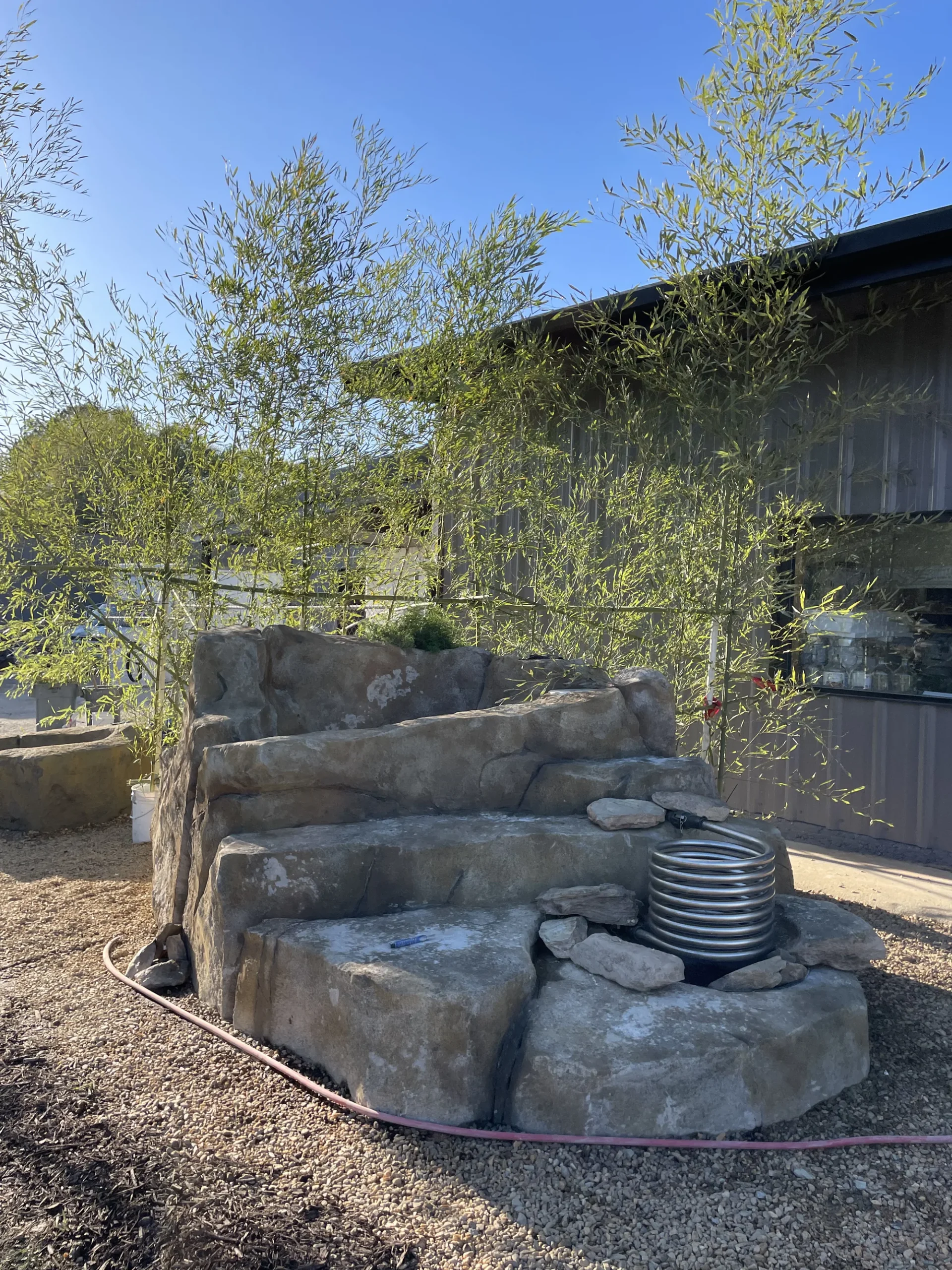 Finished paver patio with seating wall and steps installed by Worthy Landscaping.